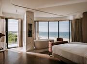 Bed and Bathtub with View of the Sea from Room