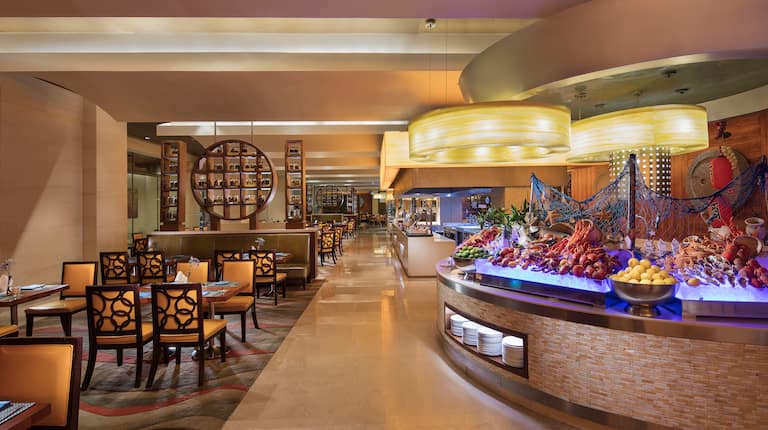 Lobby Dining area with tables, chairs, and buffet-style seafood selections