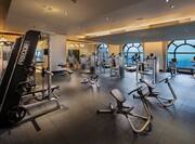 Fitness center with exercise machines and floor-to-ceiling windows with outdoor view