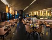 Pure Restaurant with dining tables, chairs, dining amenities, and bar