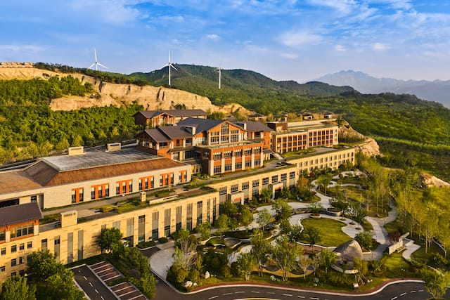 Exterior of hotel building next to windmills