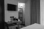 Work desk area with television and closet