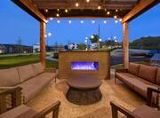exterior patio with fire place at dusk