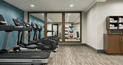 Convenient on-site fitness center featuring cardio machines.