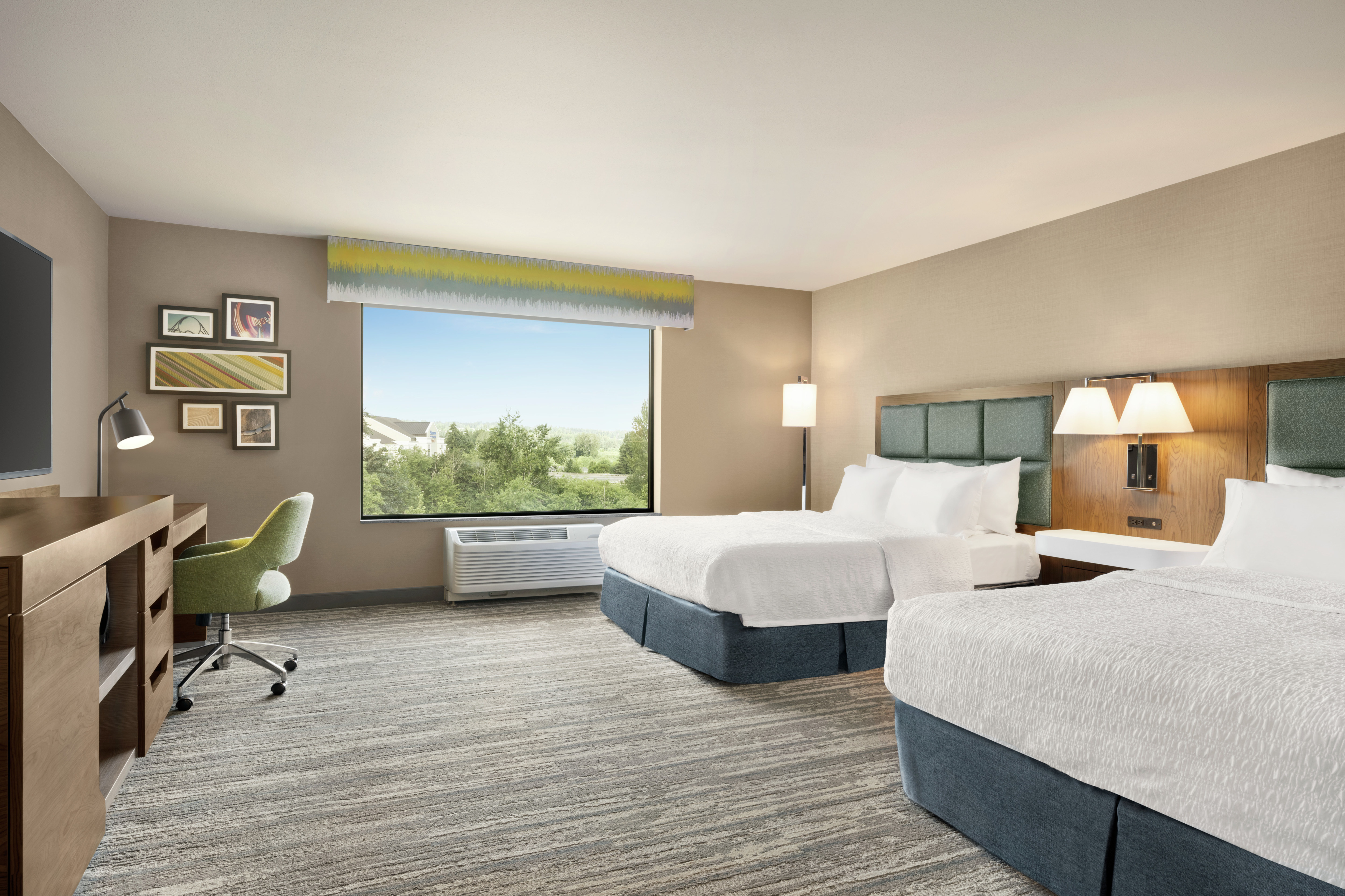 Spacious accessible guest room featuring two comfortable queen beds, work desk, and stunning outside view.
