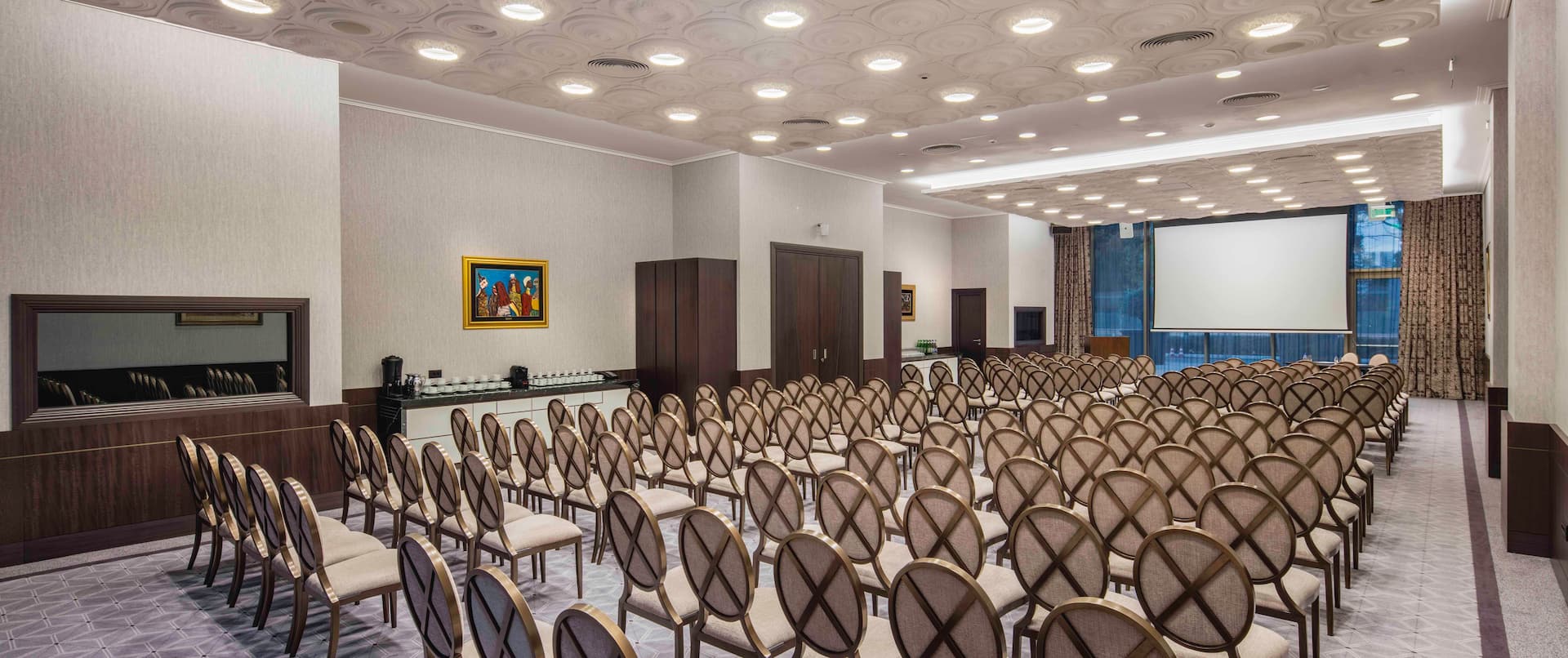 Princess Jelena Meeting Room Arranged Theater Style With Rows of Chairs Facing Projector Screen and Large WIndow