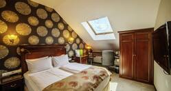 Beds in room with skylight and TV