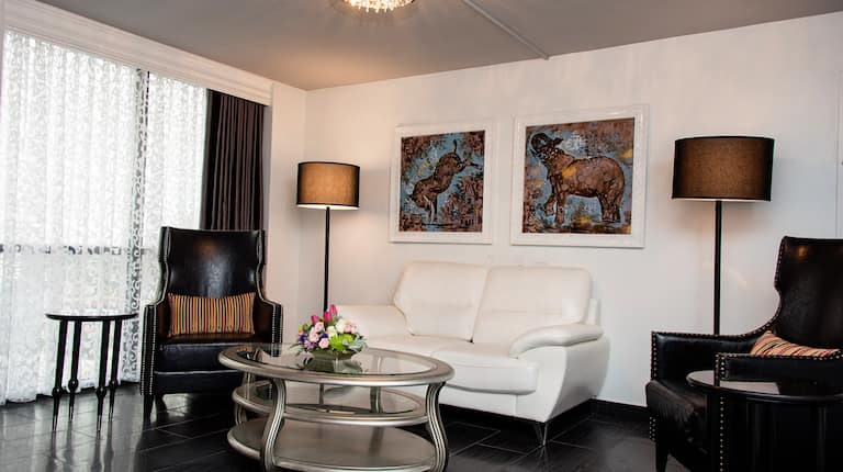 living area with sofa, and two sitting chairs.