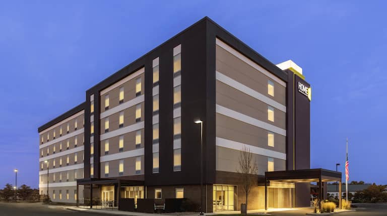 Hotel exterior illuminated at dusk with a warm and inviting glow