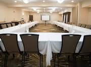 Meeting Room with U-shaped Setup and Projection Screen