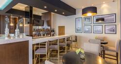 Hotel Bar Lounge Area with Bar Stools at Bar Counter
