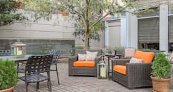 Outdoor Patio Seating Area with Soft Armchairs, Chairs and Tables