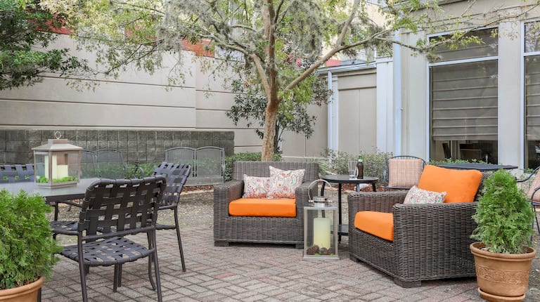 Outdoor Patio Seating Area with Soft Armchairs, Chairs and Tables