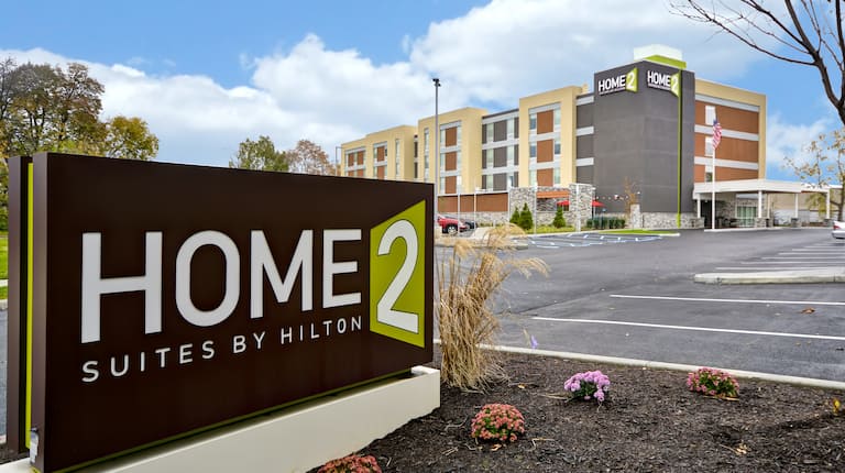Hotel Exterior Parking Lot Area and Home2 Suites by Hilton Sign