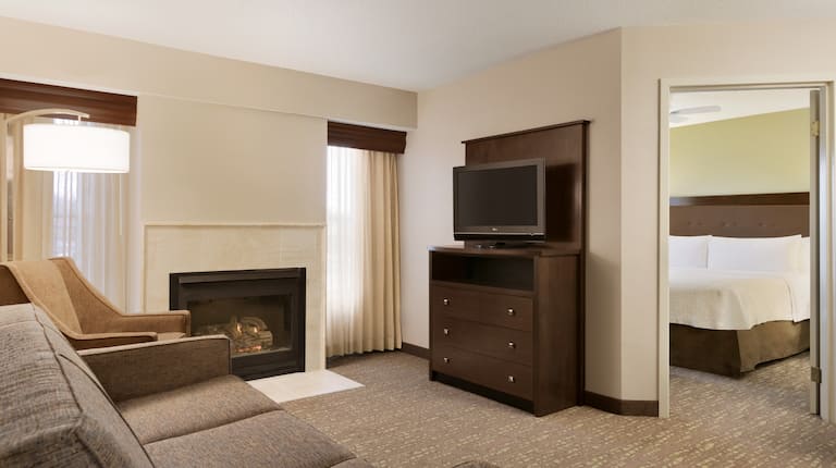 Suite Living Area with Lounge Seating, Television, Fireplace and Entry to Bedroom