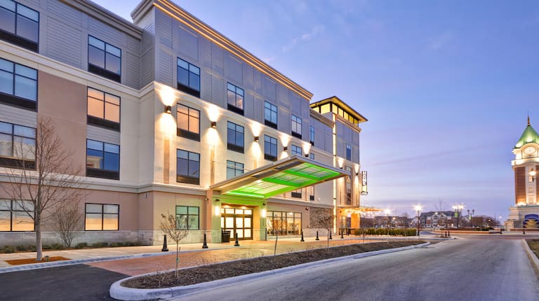 Illuminated Hotel Exterior, Entrance, Porte Cochère, and Landscaping at Dusk