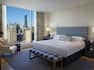 One King Bed Guest Bedroom with Armchair and City View