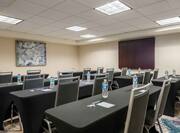  Westshore Meeting Room With Wall Art, Audio/Visual Cabinet and Classroom Set up of Tables and Chairs