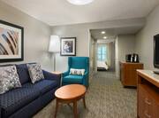 Suite Living Area with Armchair HDTV and Coffeemaker