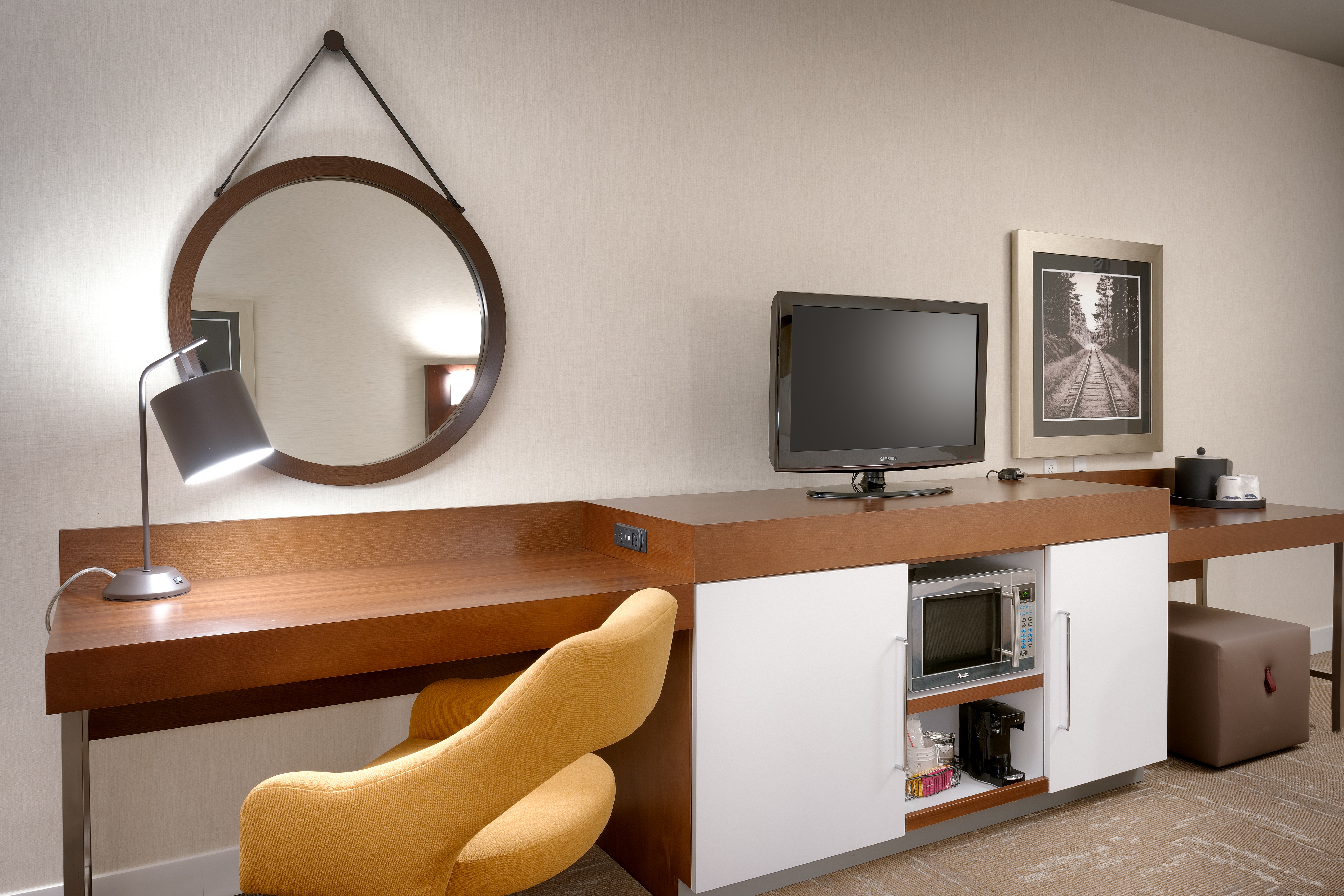 Microwave, Mini-Fridge, TV, and Work Desk with Chair and Desk Lamp in Guest Room