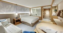 King Guestroom with Bed, Lounge Area, Work Desk, Room Technology, and View of Bathroom with Bathtub