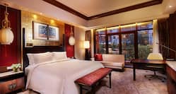 King-Sized Bed, Desk and Love Seat in Deluxe Room   