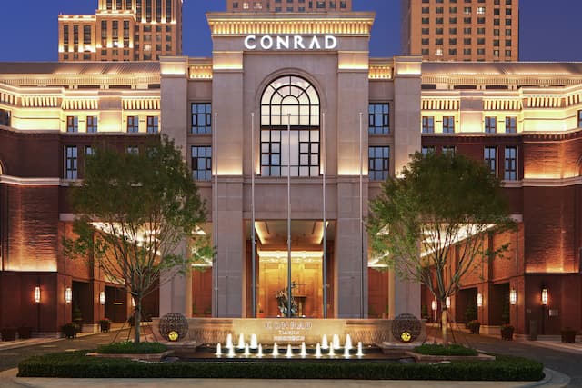 Night view of Conrad Tianjin Hotel with Trees in Front