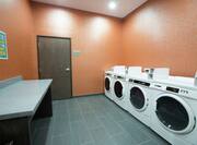 Folding Table, Coin Operated Washing and Drying Machines in Laundry Facility