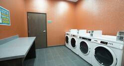 Folding Table, Coin Operated Washing and Drying Machines in Laundry Facility