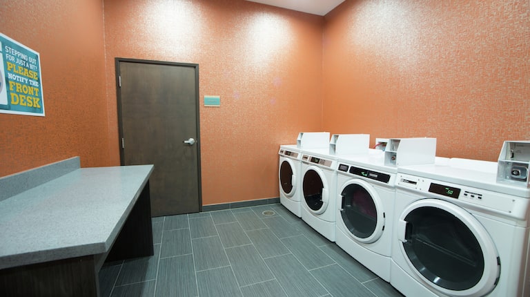 Folding Table, Coin Operated Washing and Drying Machines in Laundry Facility