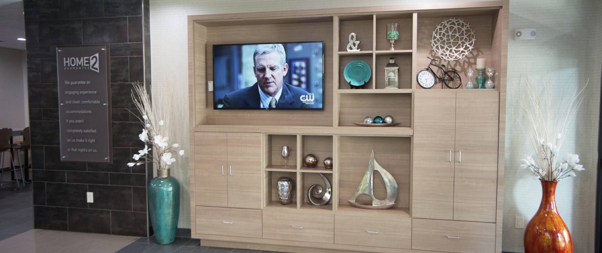 Lobby With Signage and TV in Decorated Media Cabinet