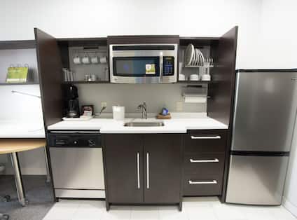 Kitchen With Microwave Over Sink, Fridge, Coffee Maker, and Dishwasher in Studio Suite