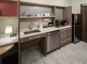 Guestroom Kitchen Area with Counter, Dishwasher, Microwave and Refridgerator