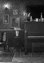 Restaurant area with piano and plants