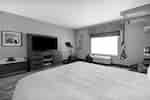 guest room with bed television and fitness center