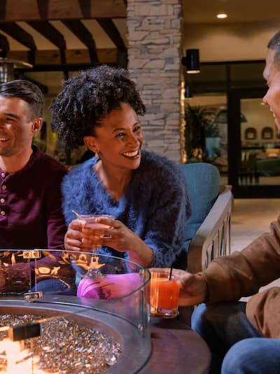 Groupe de personnes assises autour du brasero avec des boissons