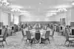 A banquet hall with elegantly set tables and chairs for a formal event