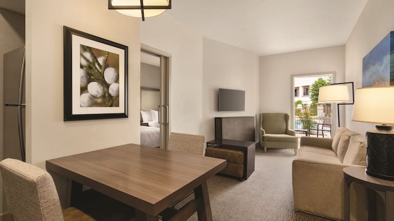 Living area in suite with tables and chairs