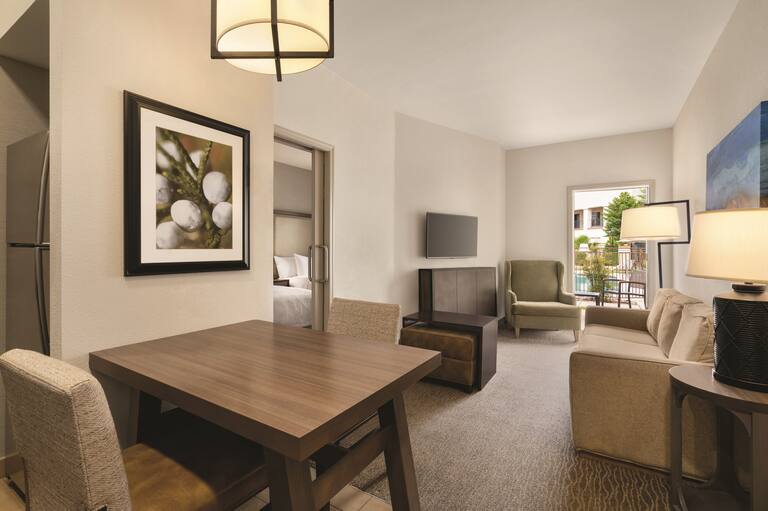 Living area in suite with tables and chairs