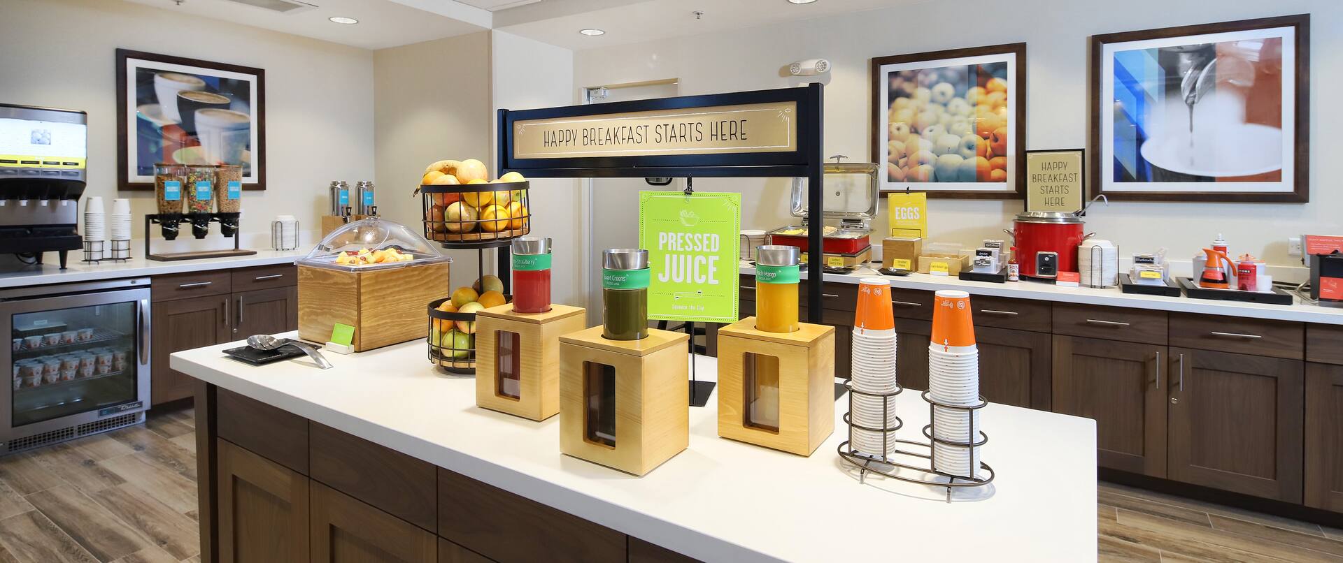 a breakfast serving area with food on counters