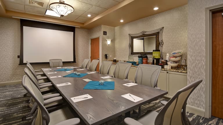 boardroom with table seating and screen
