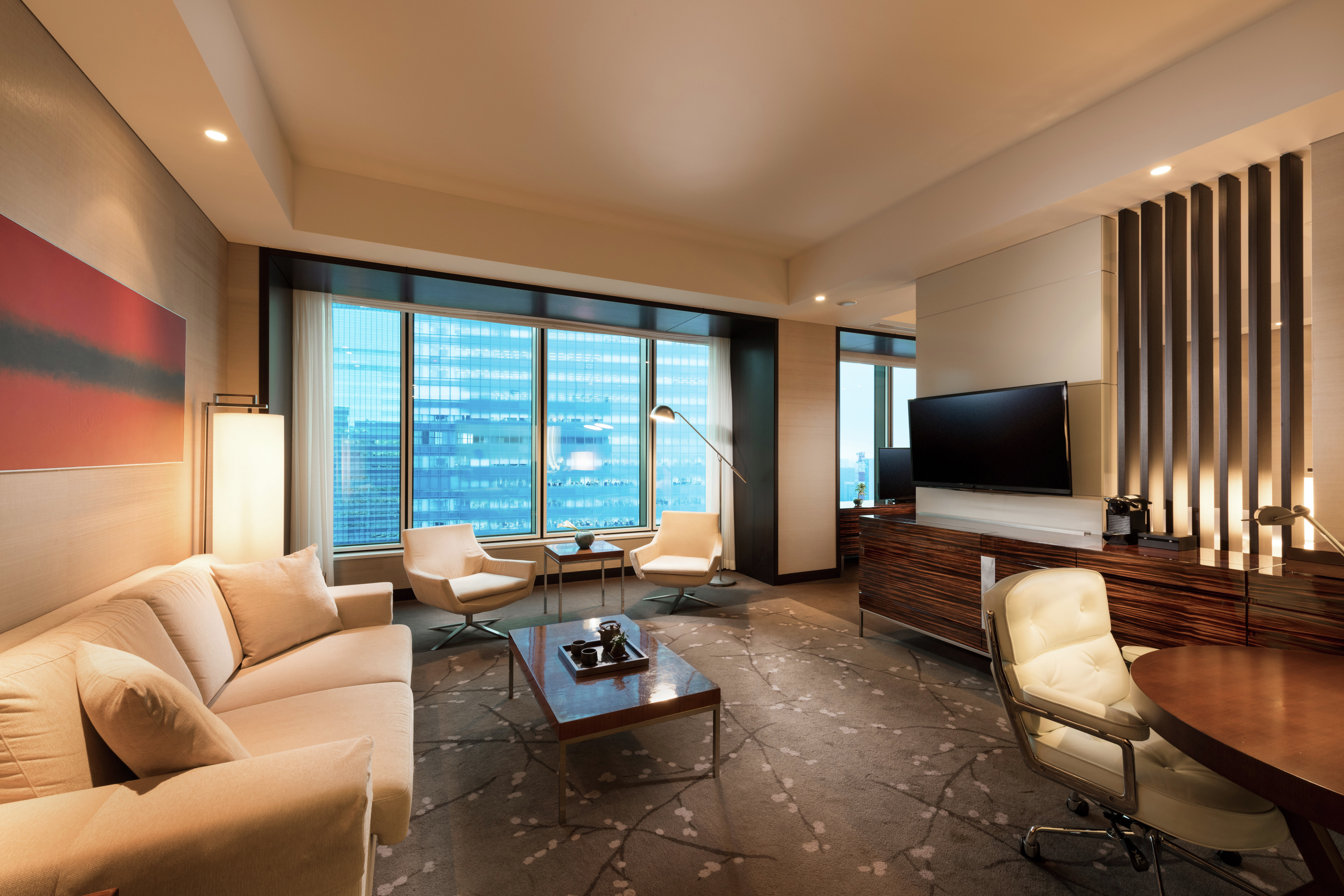 Living area in suite, with table and comfortable chairs