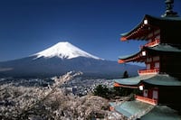 A traditional Japanese building with Mt. Fuji in the background.