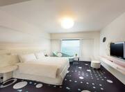 King Celebrio Ocean Guestroom with Bed, Lounge Area, Work Desk, Outside View, and Room Technology