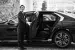 Hotel Concierge holding open a vehicle door