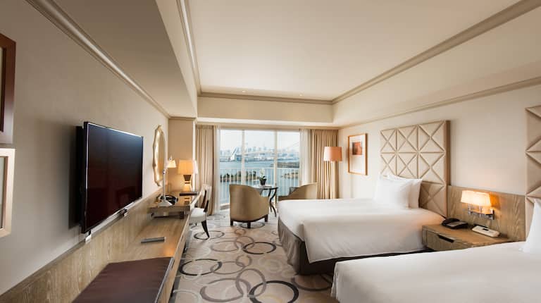 Twin beds Guest Bedroom with Wall Mounted HDTV, Work Desk and Outside View