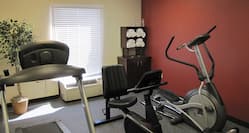  Fitness Center With Elliptical, Treadmill, Bike, and Towel Station