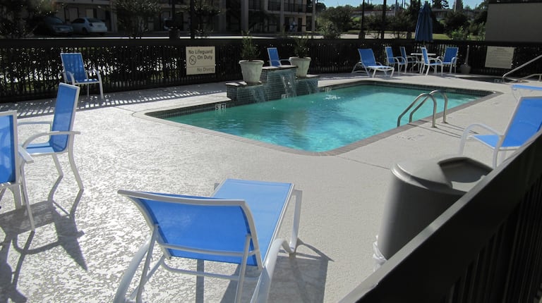Outdoor Swimming Pool With Loungers, Chairs and Tables