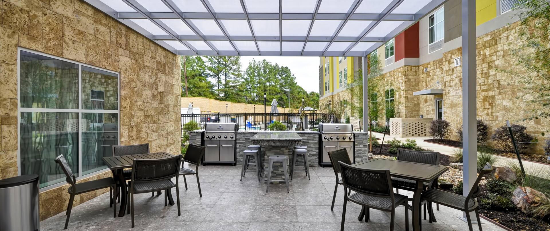 Tables and Chairs on Outdoor Patio with Two Grills