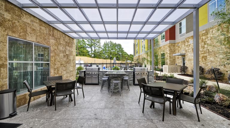 Tables and Chairs on Outdoor Patio with Two Grills